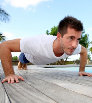 Man Doing Pushups on Pool Deck