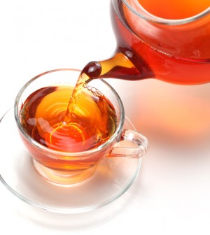 Glass Teapot Pouring Oolong Tea into Glass Teacup