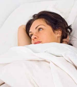 Woman Waking up in the Morning in White Sheets