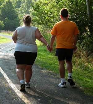 Overweight Couple Walking Down Wooded Road