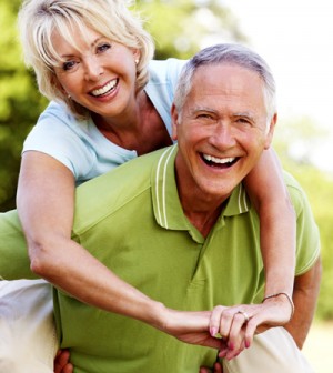 Older Couple Piggy Back Ride Laughing
