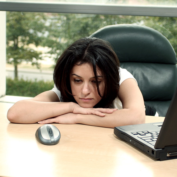 Girl Tired at her Desk During The Day