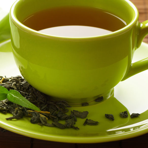 Green Tea in Green Teacup with Leaves