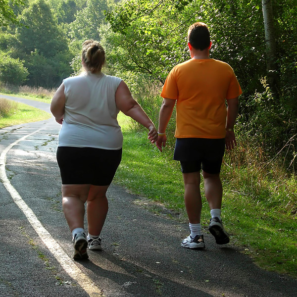Overweight Couple Walking Down Wooded Road