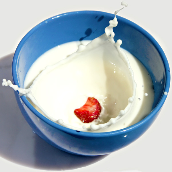 Strawberry Dropping into a Bowl of Milk