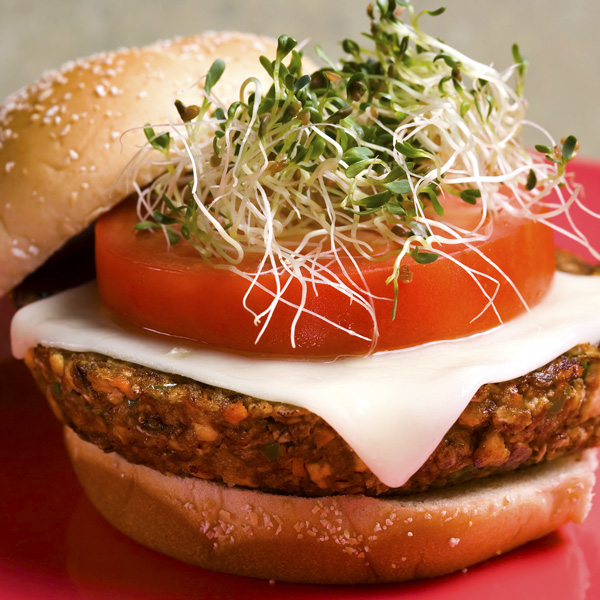 Tofu Burger with Sprouts, Tomato and Cheese on a Seeded Bun